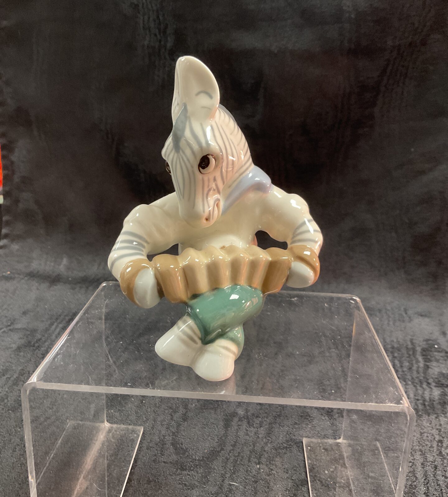 Vintage Royal Dux zebra figurine playing an accordion.