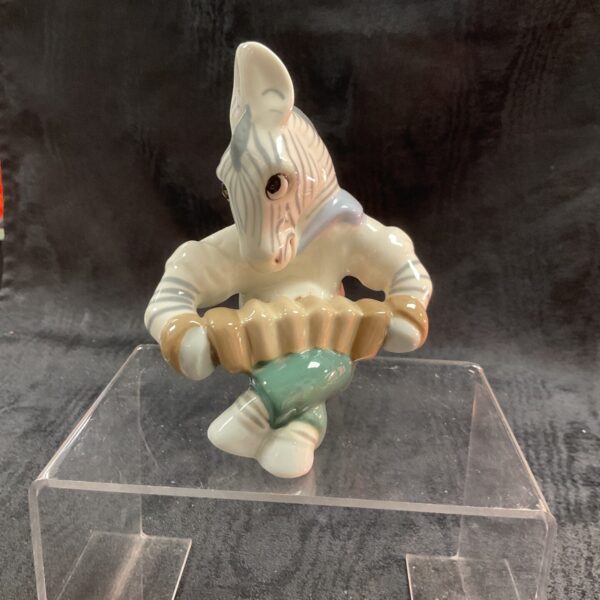 Vintage Royal Dux zebra figurine playing an accordion.