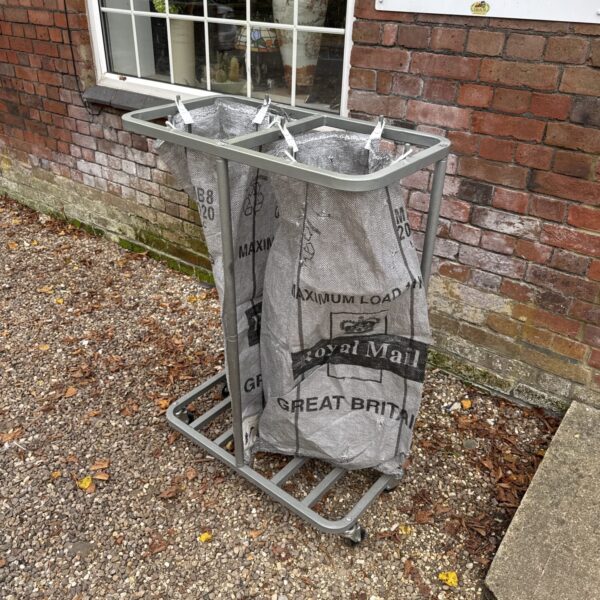 Vintage Royal Mail parcel bag stand with two bags.
