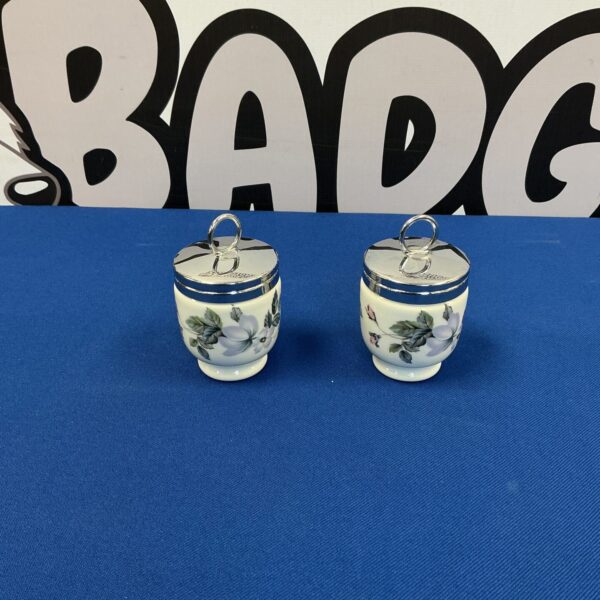 Antique Royal Worcester egg coddlers, a delicate porcelain pair with floral decoration.