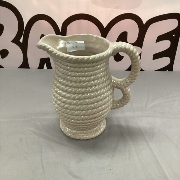 Vintage ceramic jug with a unique rug effect texture.