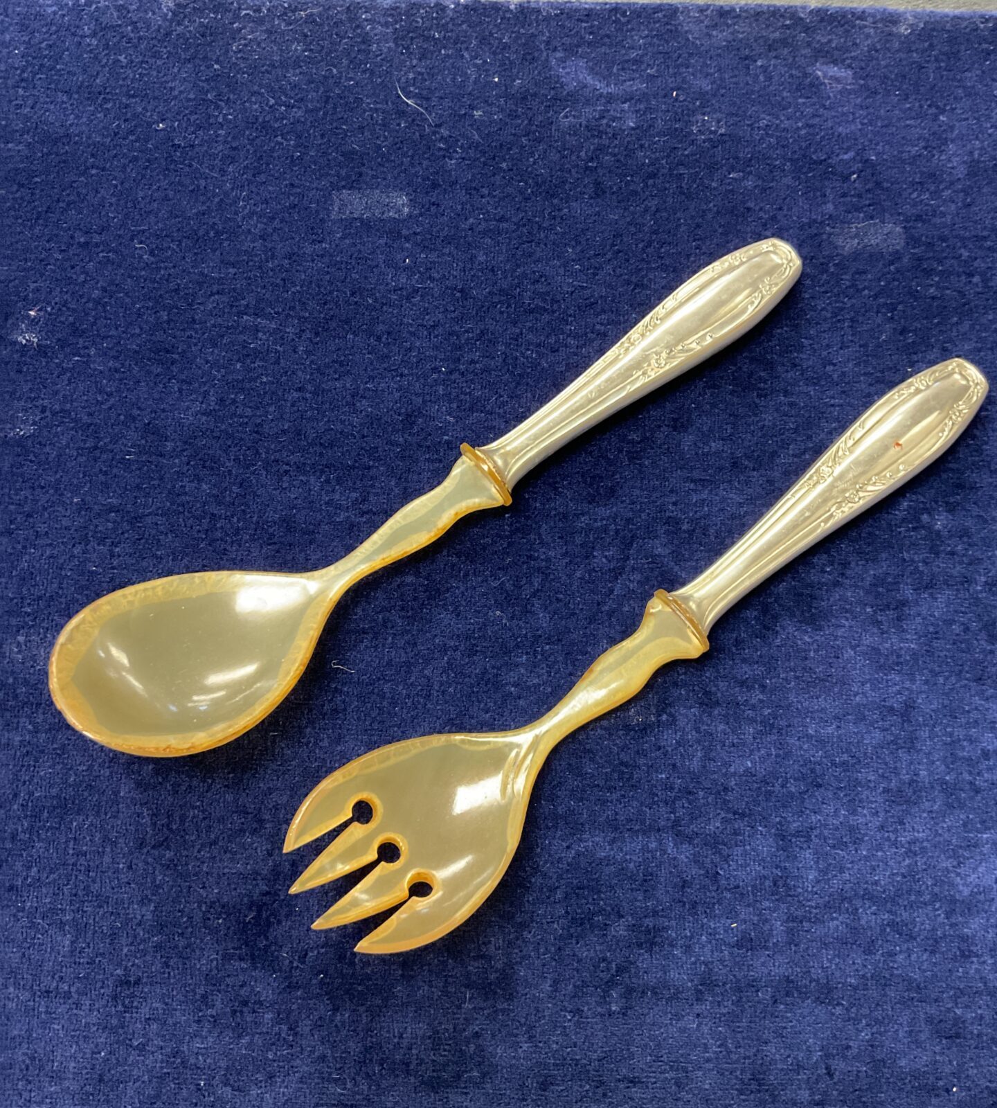 Antique Russian salad servers with ornate silver detailing.