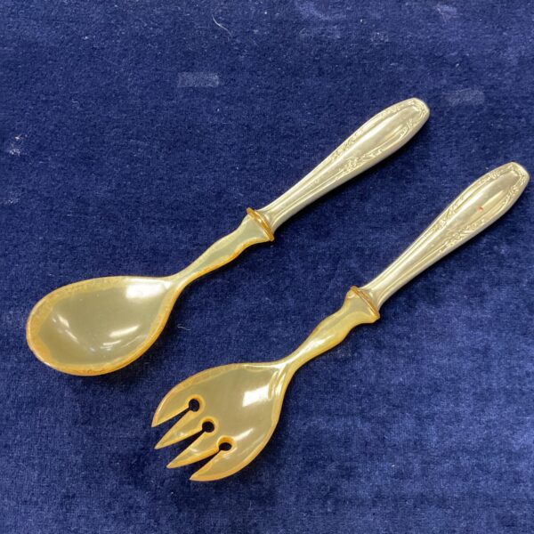 Antique Russian salad servers with ornate silver detailing.