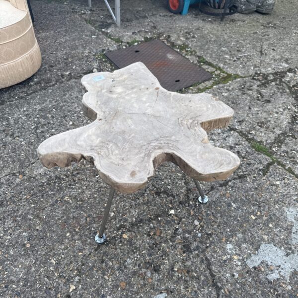 Rustic wood side table with starburst top and metal legs.