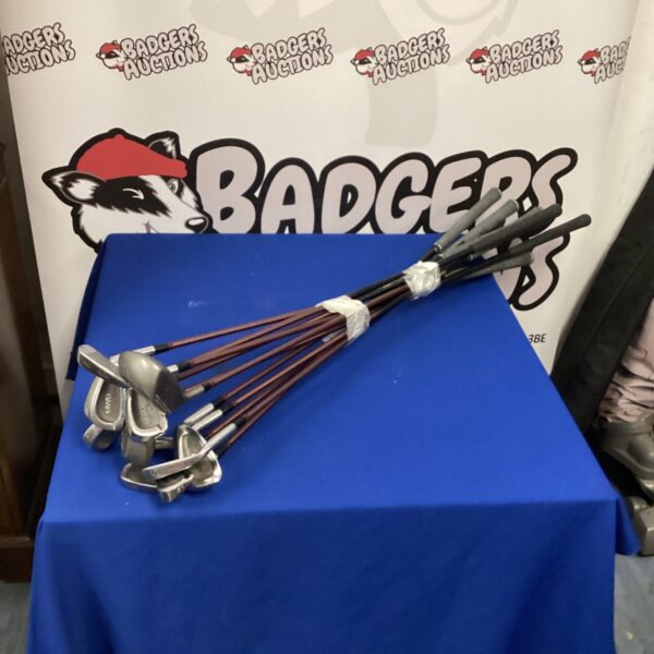 Vintage Ryder golf club set displayed on a table.