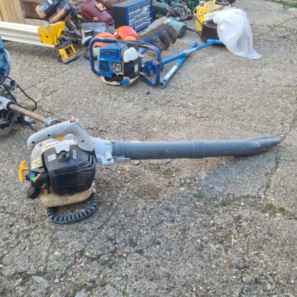 Ryobi petrol blower side view, powerful garden leaf clearing tool.