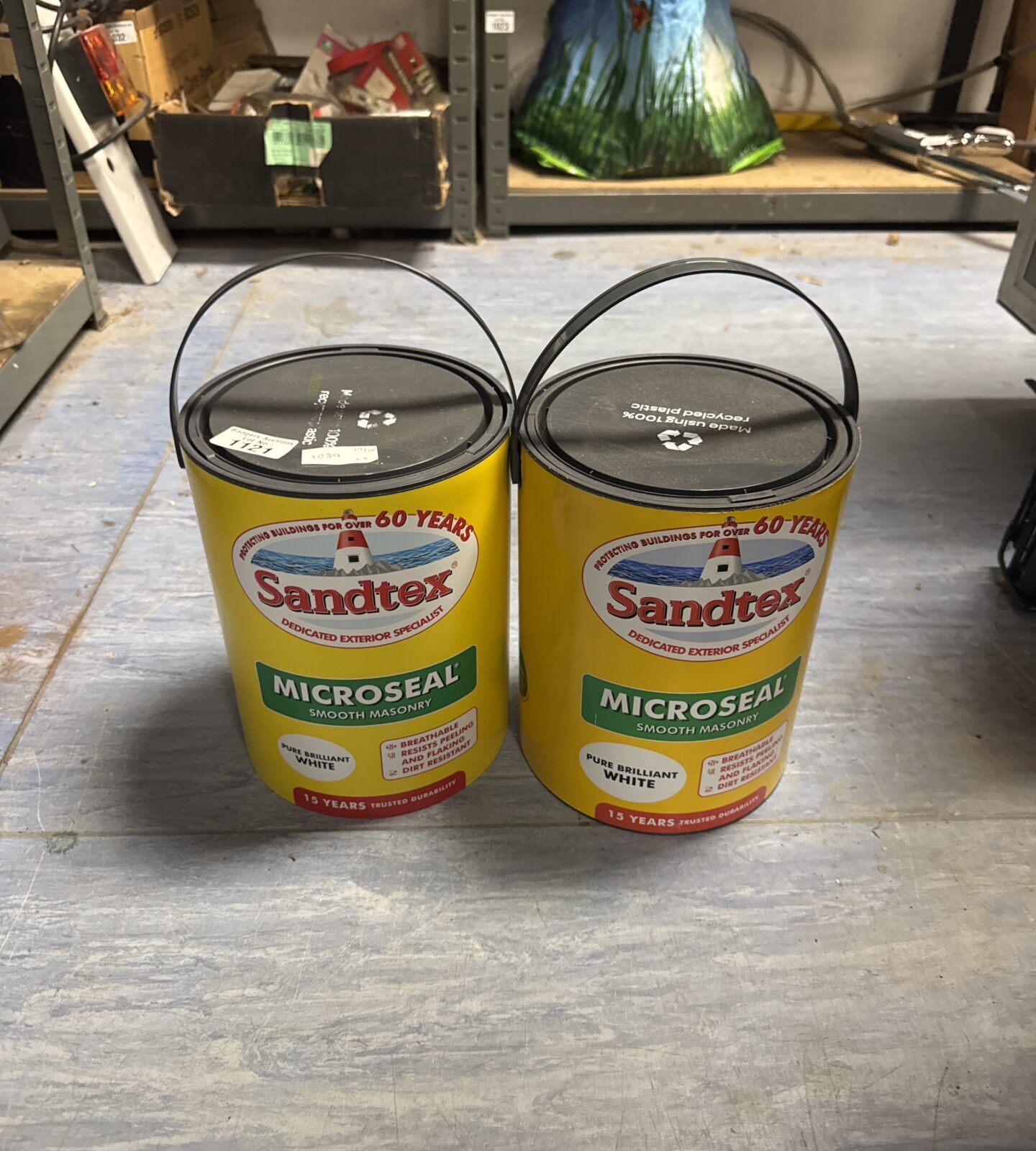 Two tubs of Sandtex Microseal brilliant white masonry paint.