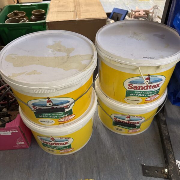Four tubs of assorted Sandtex masonry paint for garden projects.