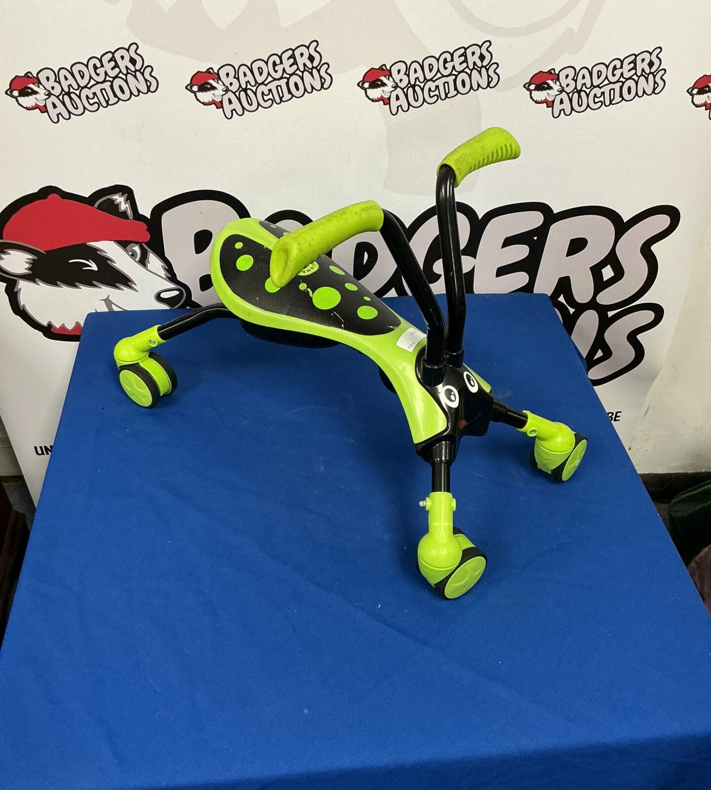 Bright green and blue Scramble Bug ride-on toy for children.