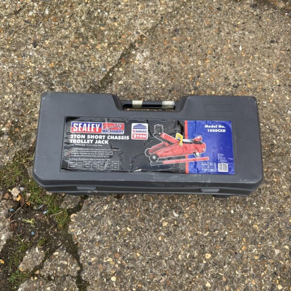 Red Sealey 2 ton trolley jack for automotive repairs.