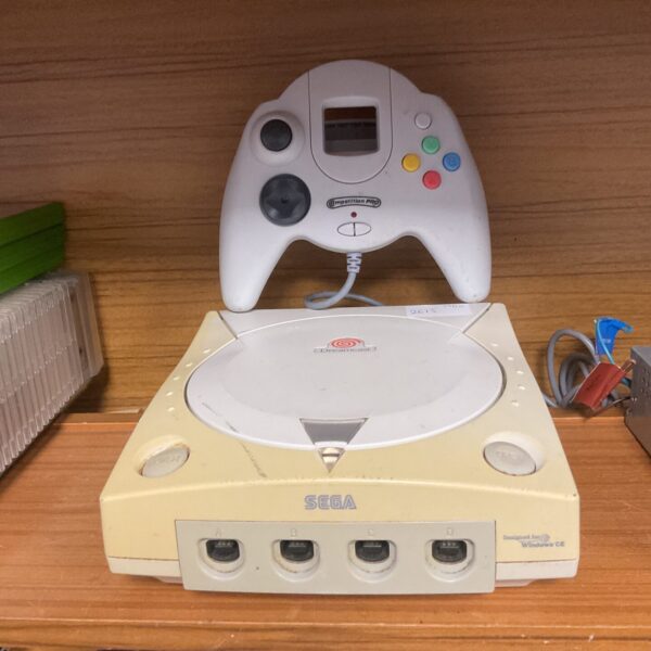 Sega Dreamcast console with Competition Pro gamepad for retro gaming.