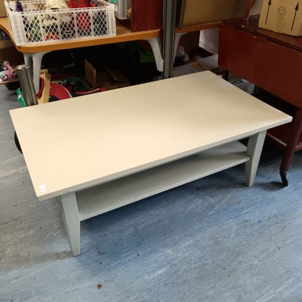 Distressed shabby chic coffee table in a living room setting.