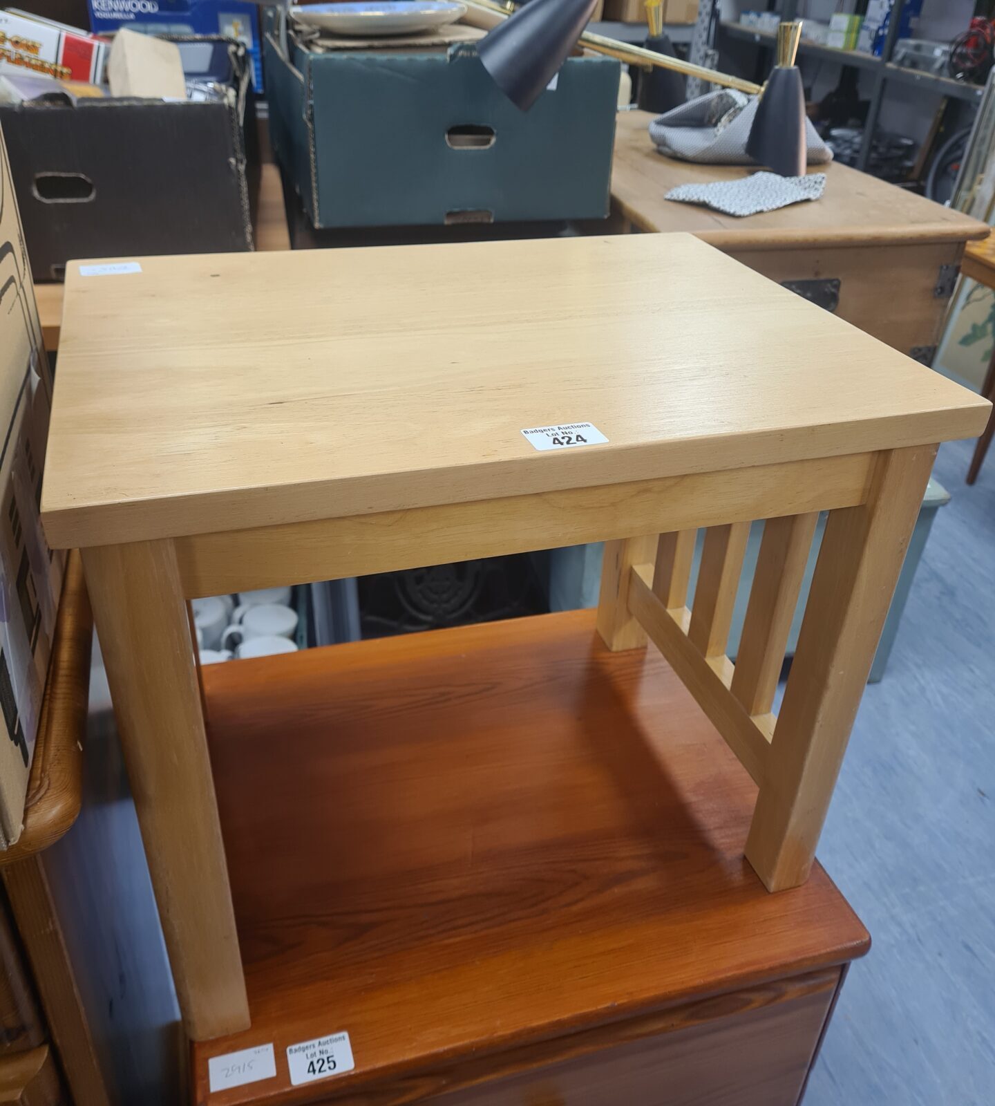 Small beach style side table with light wood finish.