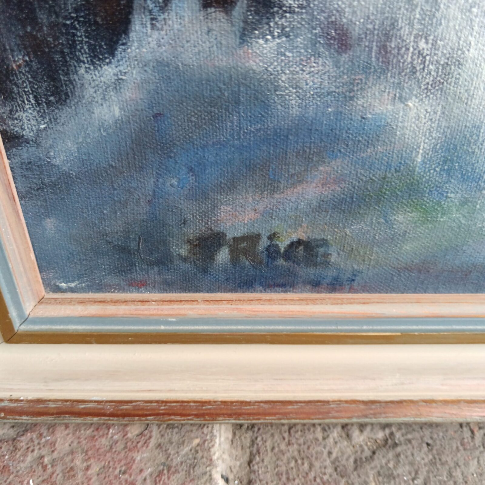 Close-up of signed "Price" on vintage seascape oil painting.
