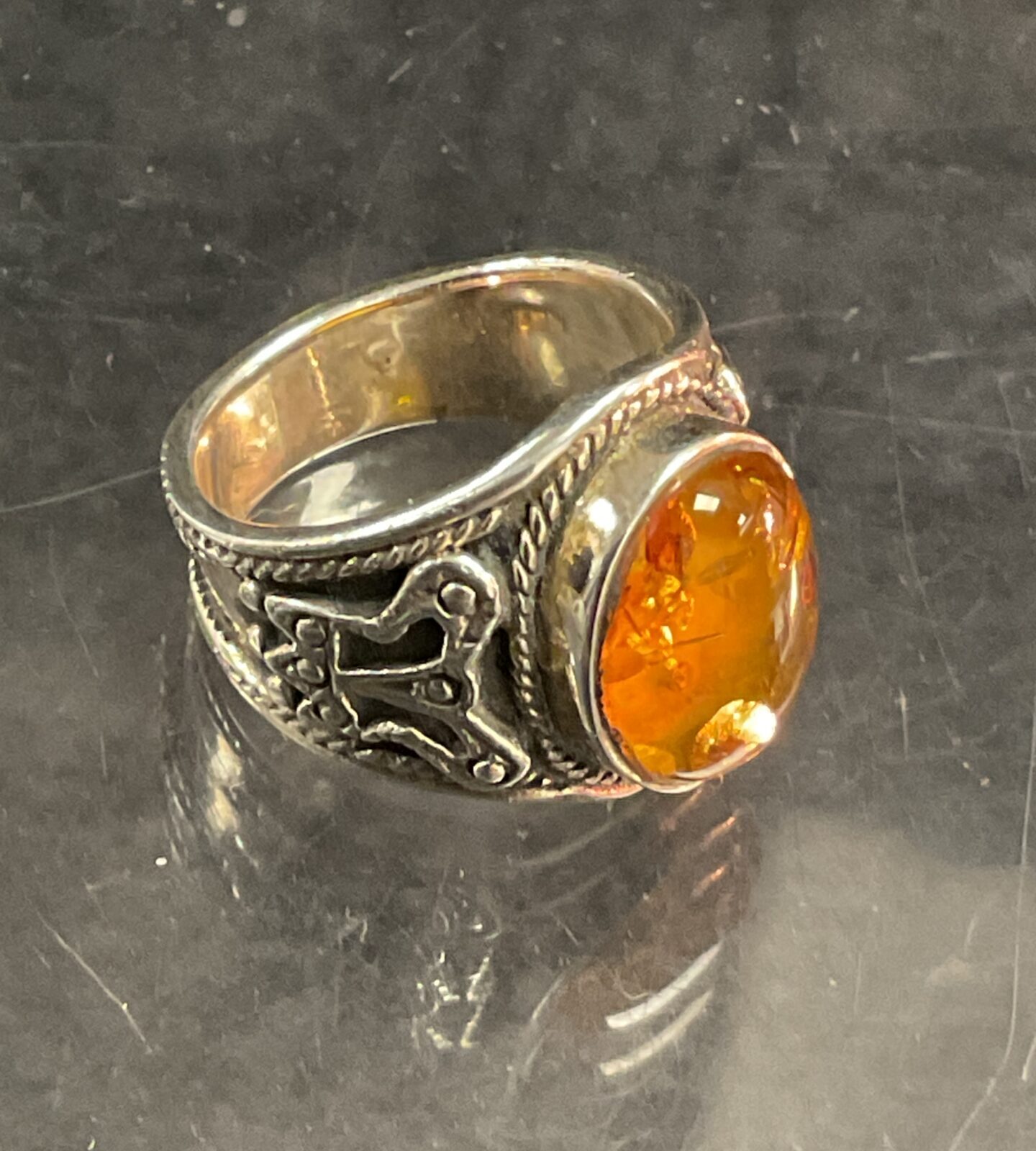 Vintage silver ring with a warm amber stone.