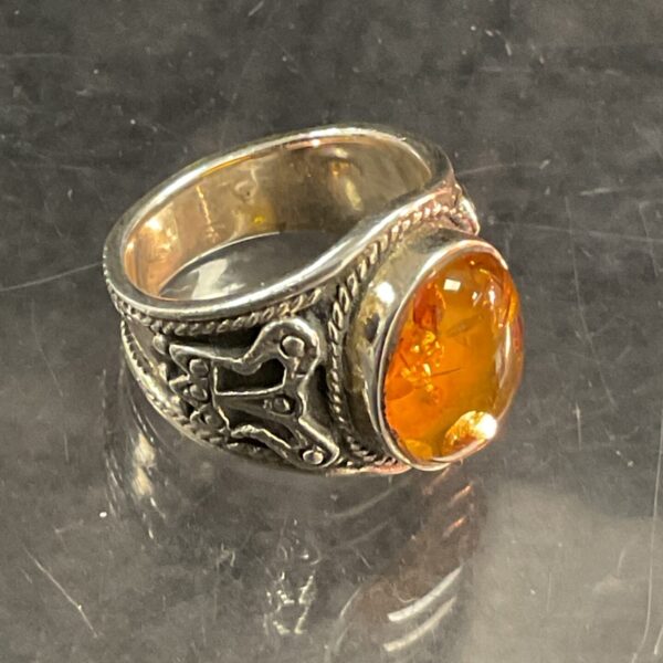 Vintage silver ring with a warm amber stone.