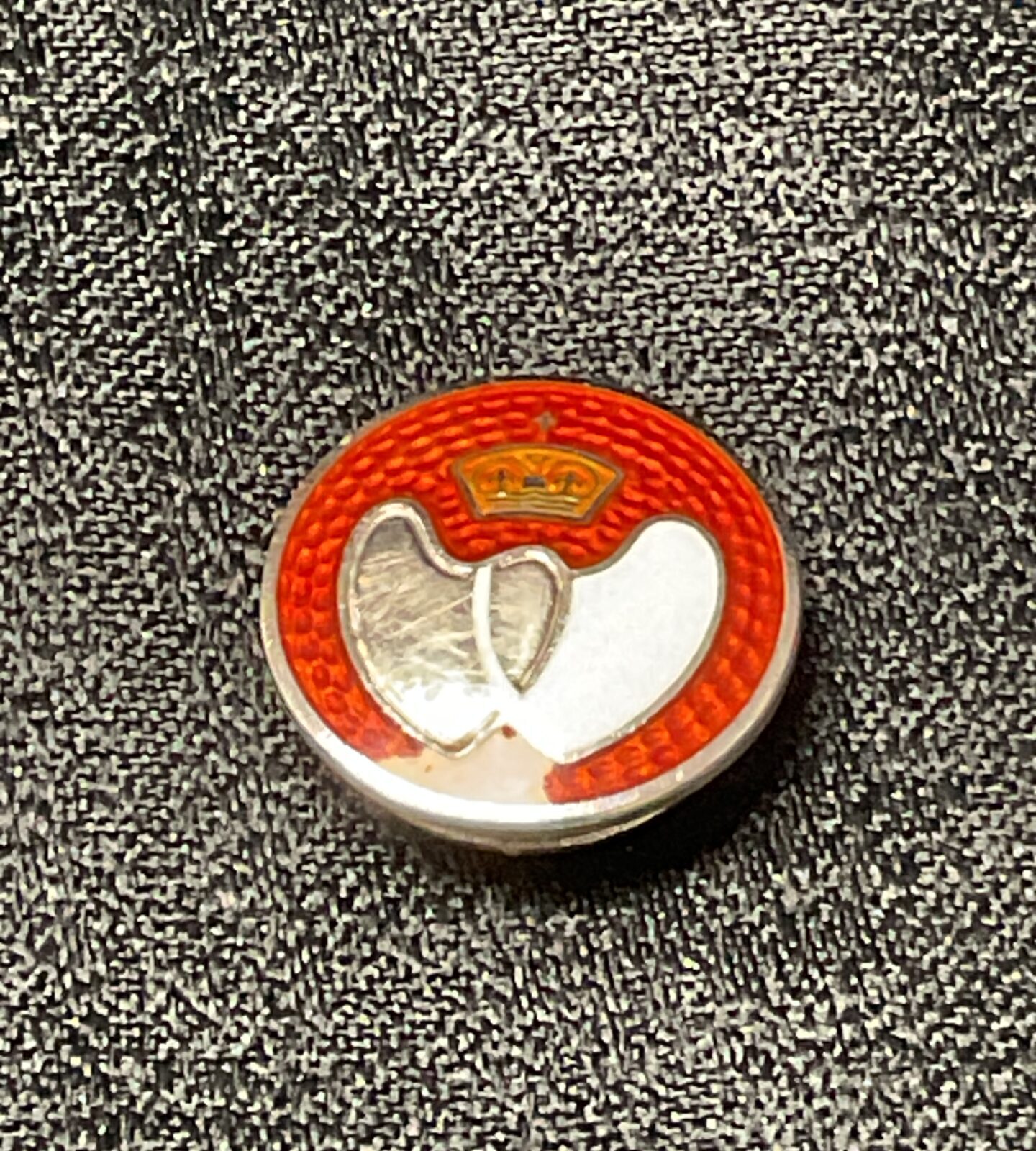 Vintage silver blood donor badge with red enamel cross.