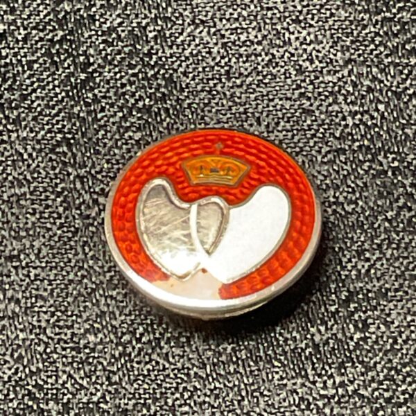Vintage silver blood donor badge with red enamel cross.