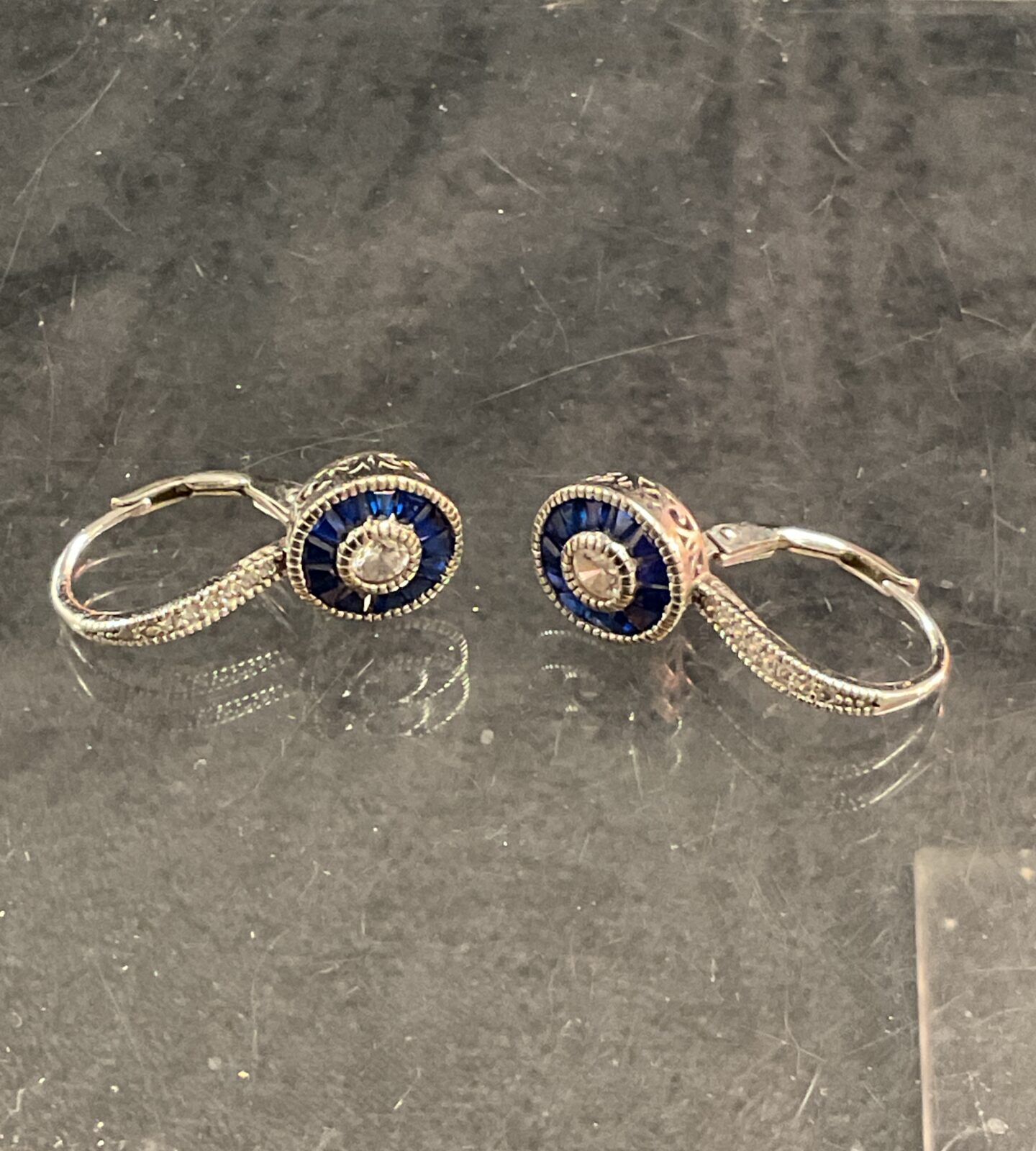 Elegant silver lever back earrings with blue and white stones.
