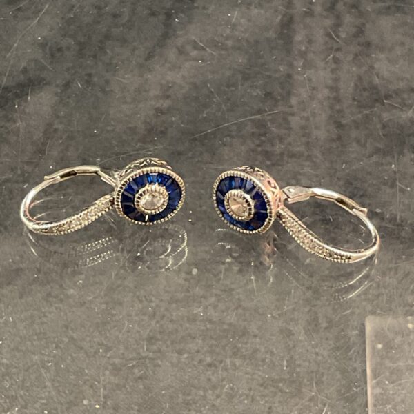 Elegant silver lever back earrings with blue and white stones.
