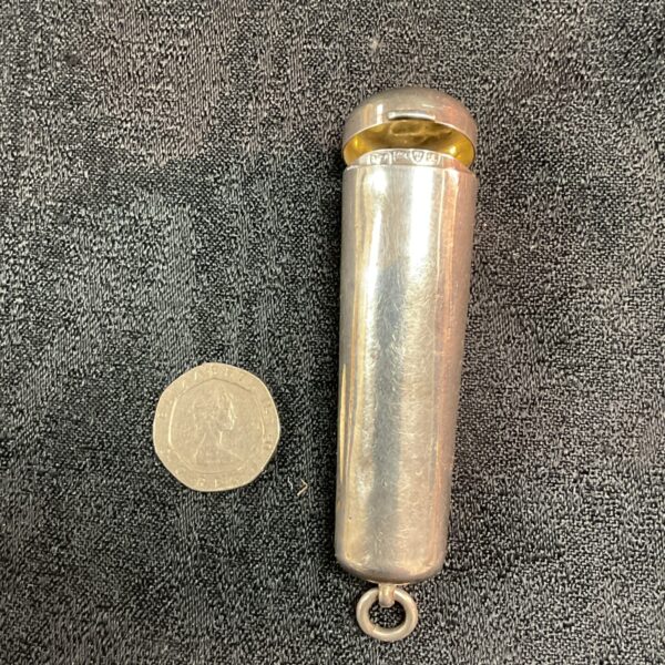 Antique silver cheroot holder with a coin for scale.