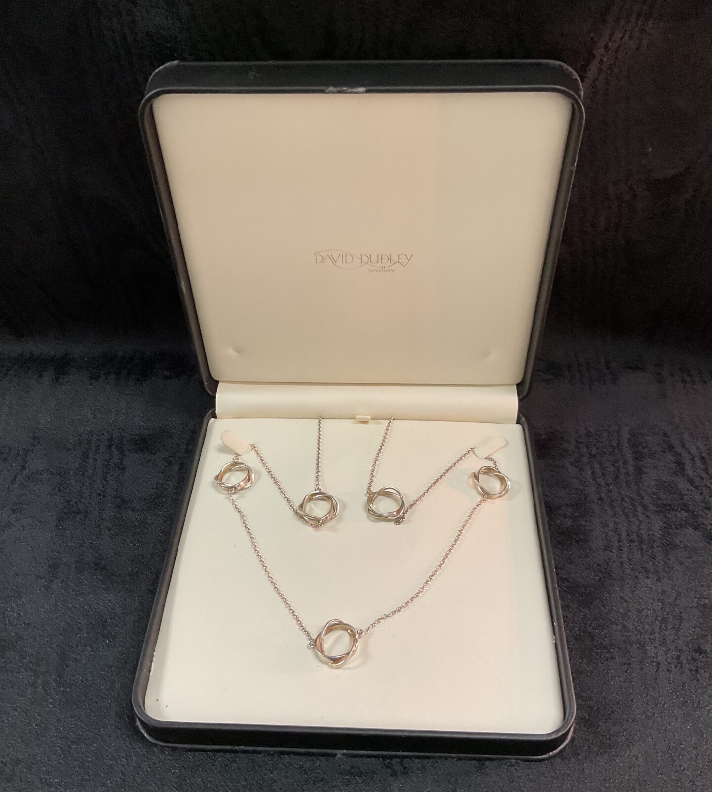Side view of silver circle necklace, dainty pendant design.