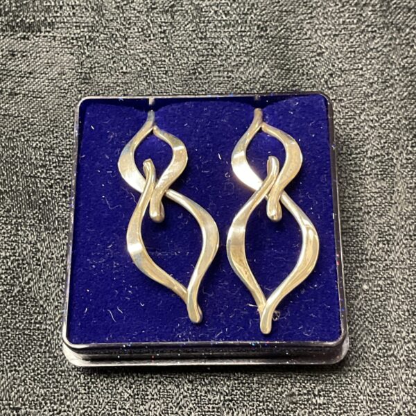 Elegant silver drop earrings with a curved design.