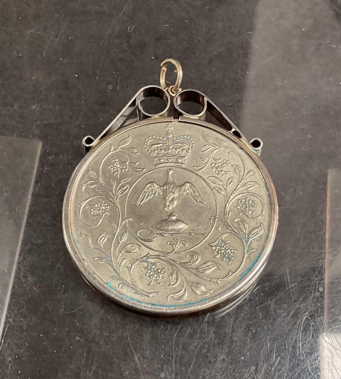 Intricate silver Jubilee coin mount with eagle design.