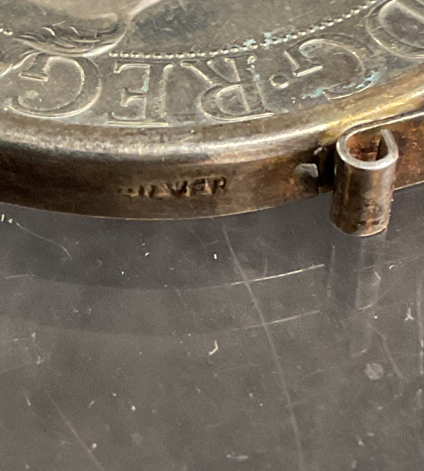 Side view of vintage silver Jubilee coin mount.