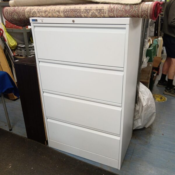 Large silver metal filing cabinet with four drawers.