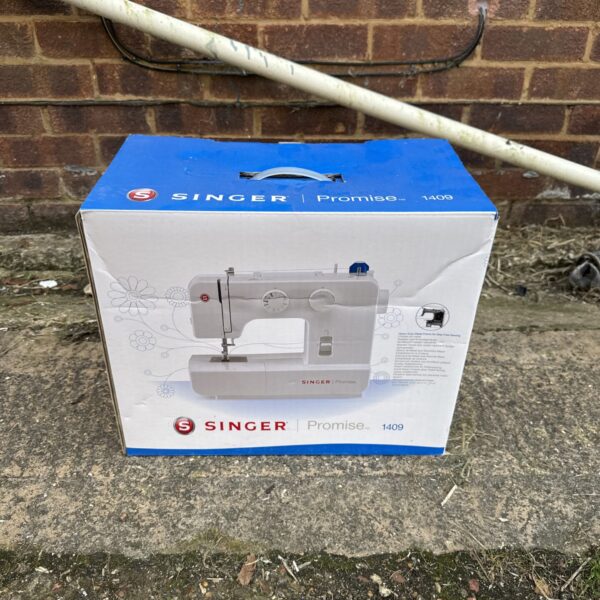 Vintage Singer Promise 1409 electric sewing machine in used condition.