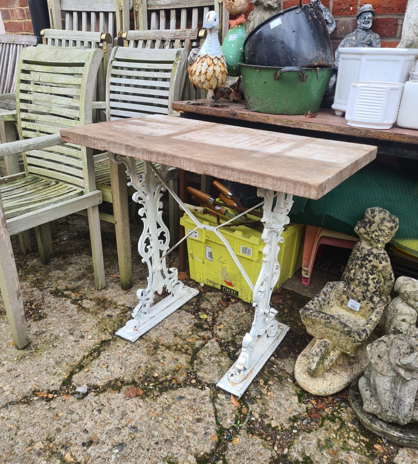 Vintage Singer treadle table with wooden top and cast iron base.