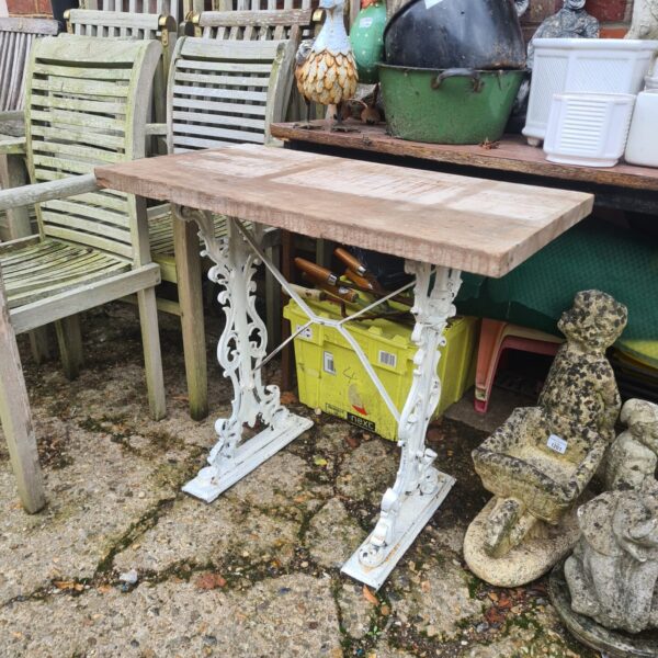Vintage Singer treadle table with wooden top and cast iron base.