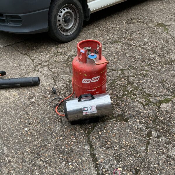 SIP space heater with full gas bottle for workshop or outdoor use.