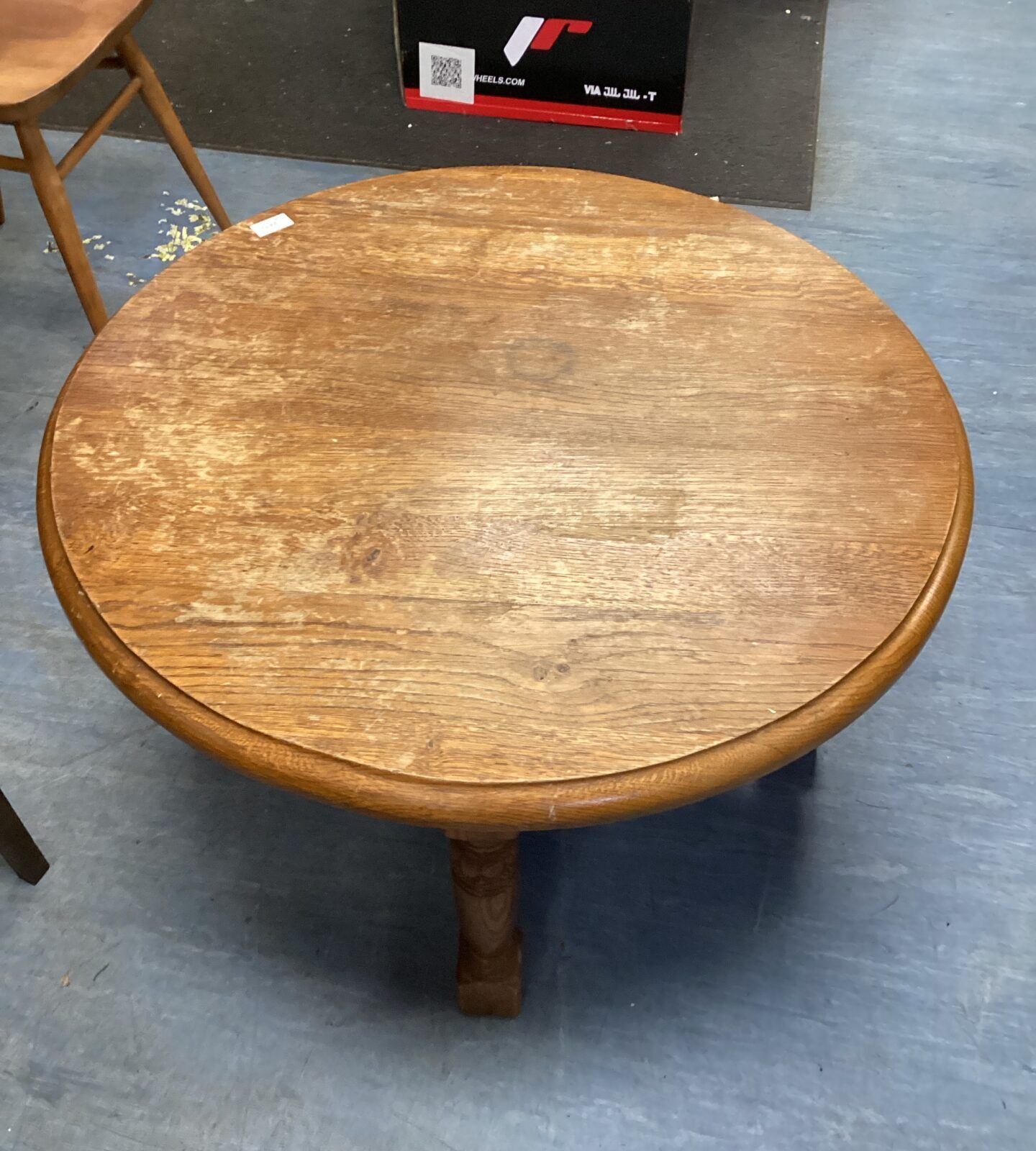 Antique small round oak table with a warm honey tone.