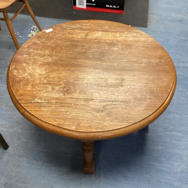 Antique small round oak table with a warm honey tone.