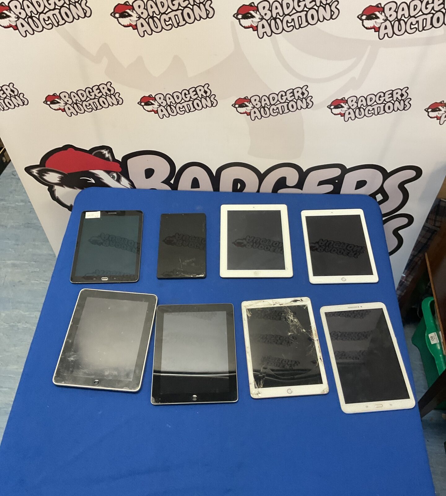 Group of eight used smart tablets including Apple iPads and Samsung.
