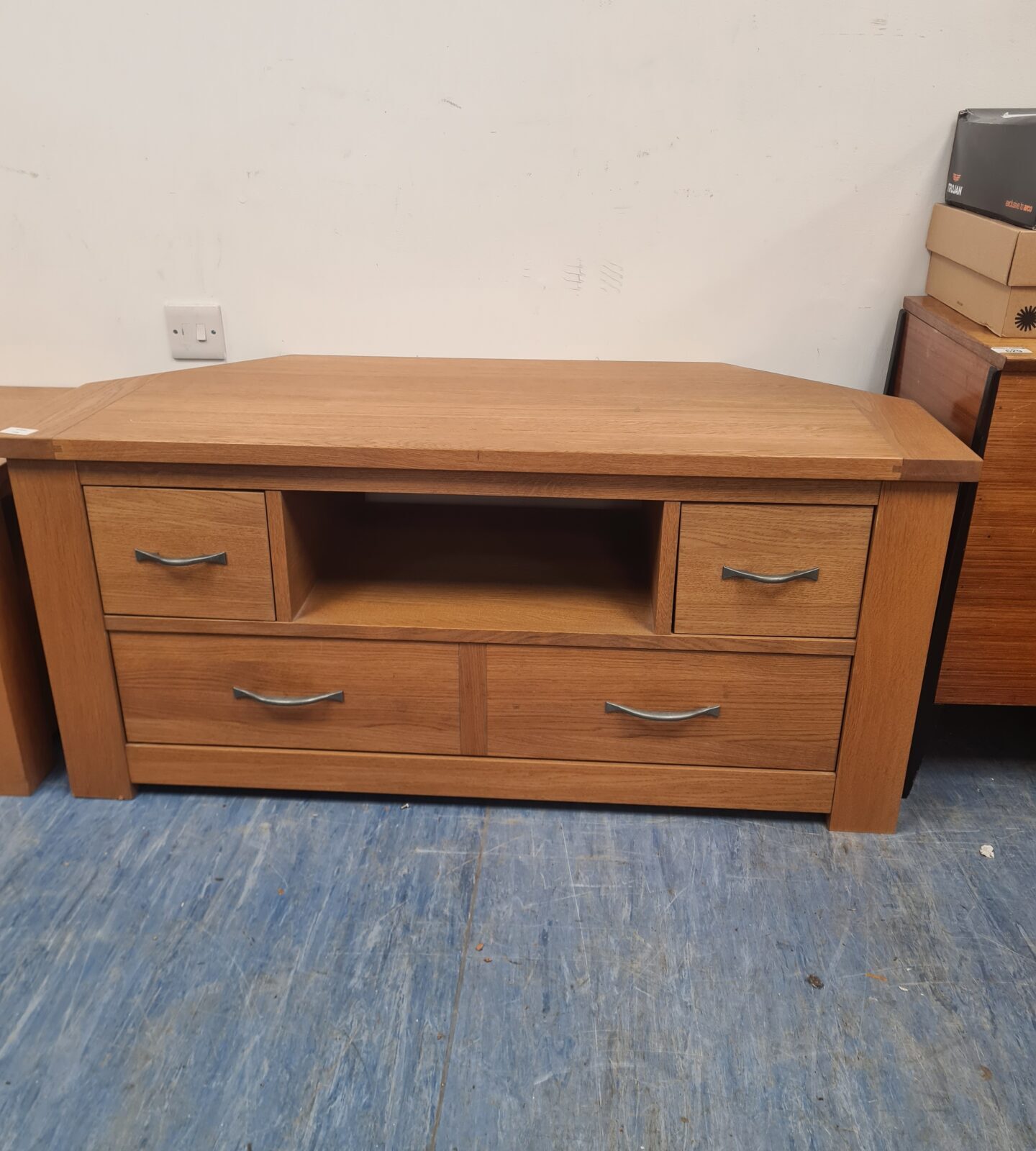 Solid oak coffee table with three drawers for living room storage.