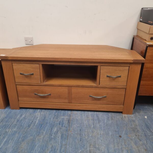 Solid oak coffee table with three drawers for living room storage.