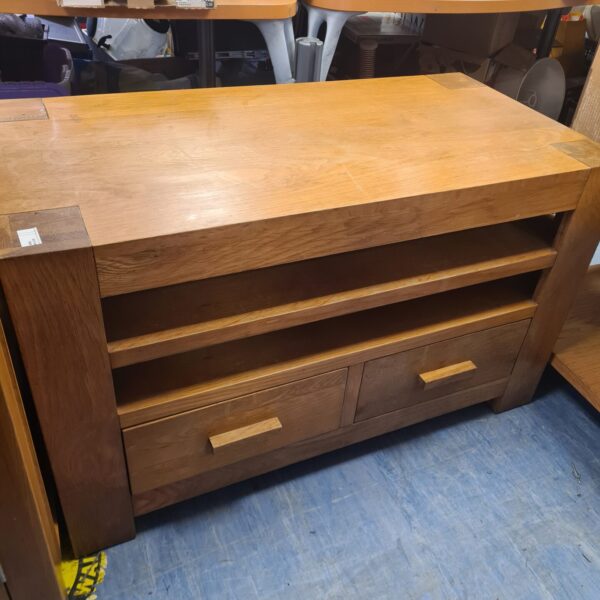 Vintage solid oak media cabinet with drawers and doors.