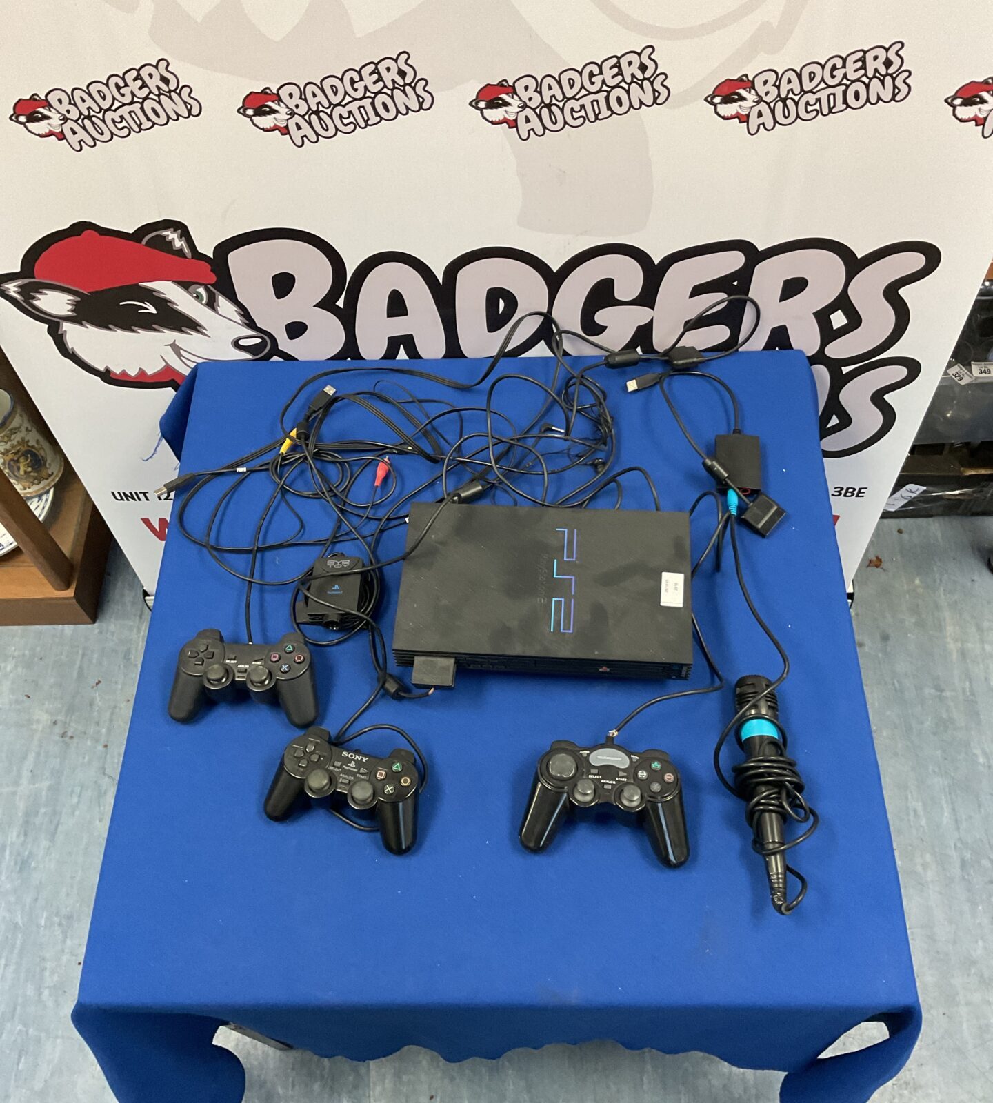 Sony Playstation 2 console with controllers and Singstar microphone.