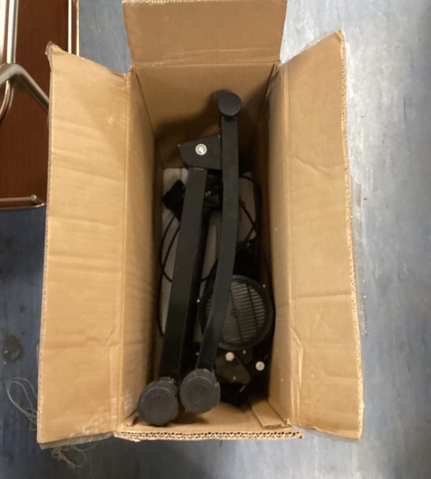 Sportneer magnetic bike trainer inside cardboard box.