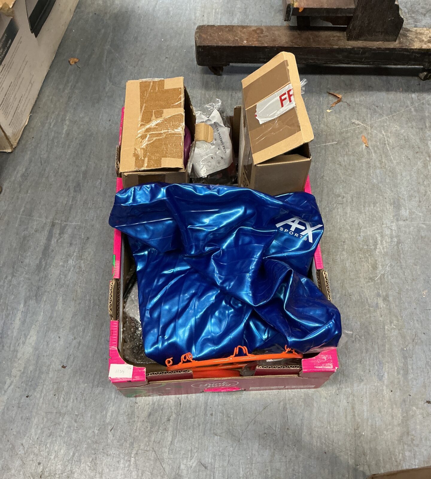 Blue protective pad within a sports equipment lot.