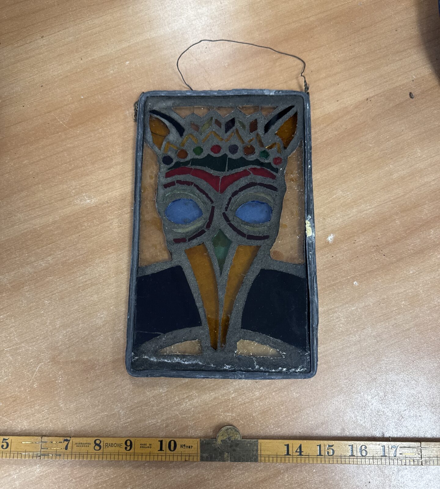 Antique stained glass portrait of a medieval doctor with lead edging.