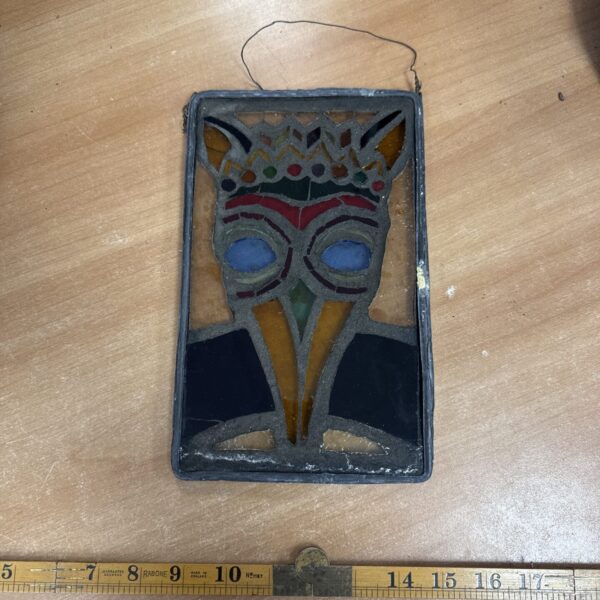 Antique stained glass portrait of a medieval doctor with lead edging.