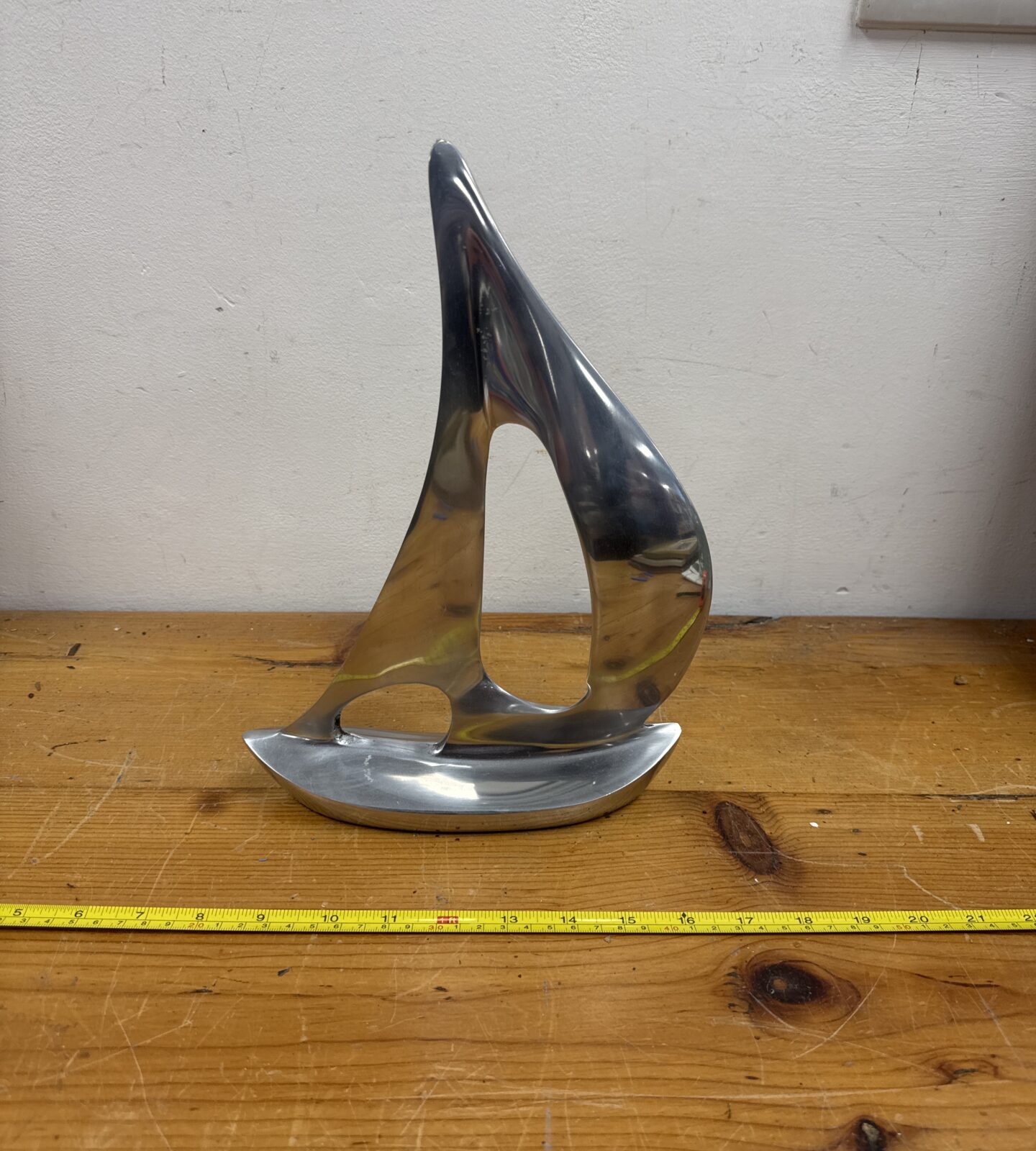 Polished stainless steel yacht ornament for nautical decor.