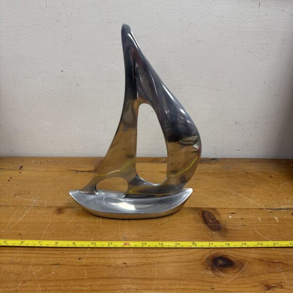 Polished stainless steel yacht ornament for nautical decor.