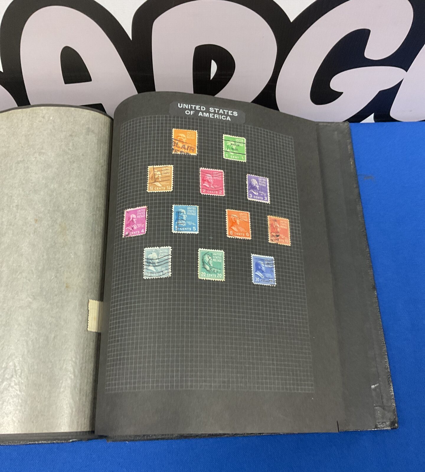 Close-up of mounted stamps in a vintage stamp album.
