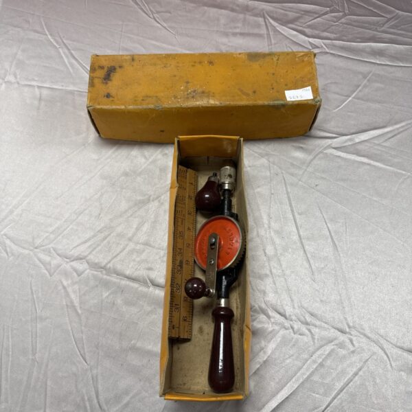 Vintage Stanley hand drill with Rabone wooden ruler for woodworking.