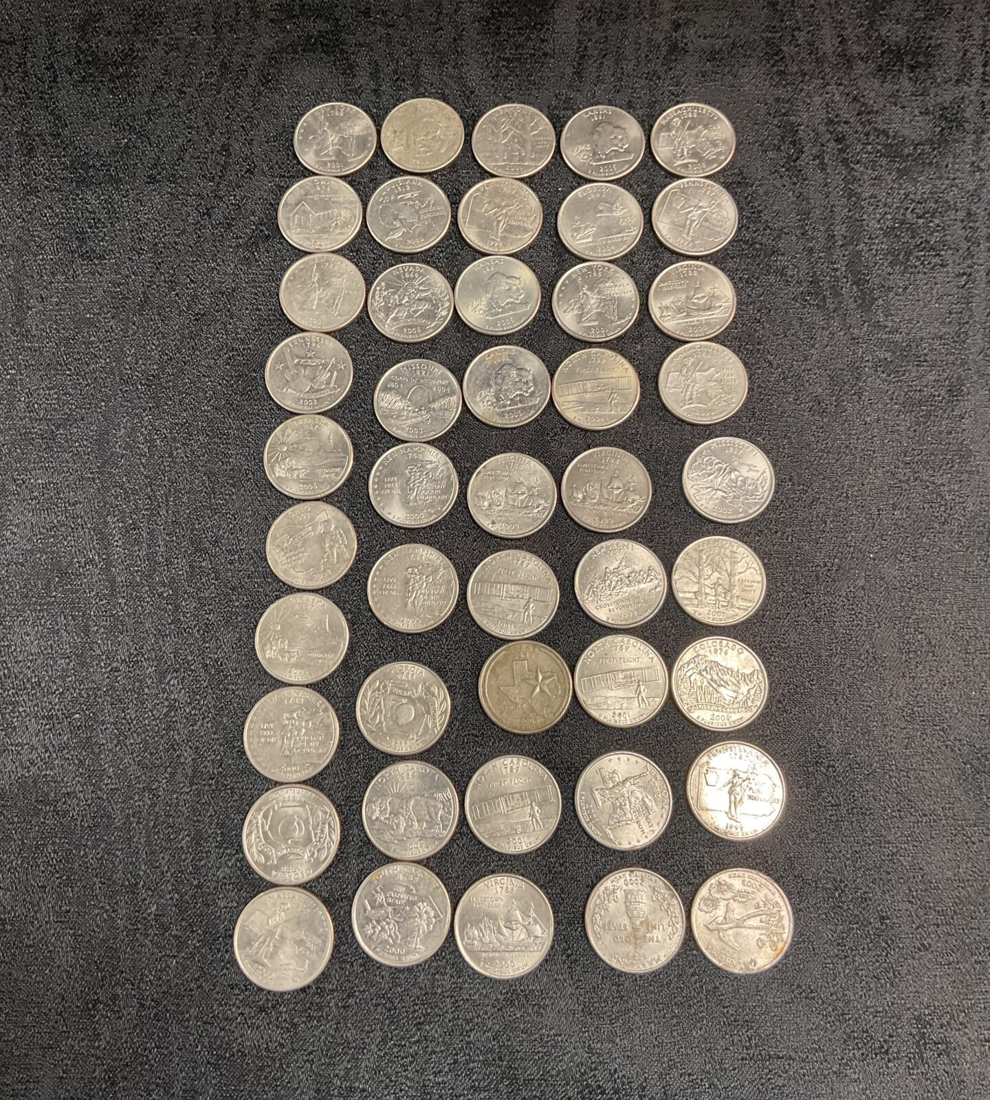 Lot of fifty US State Quarters for coin collectors.